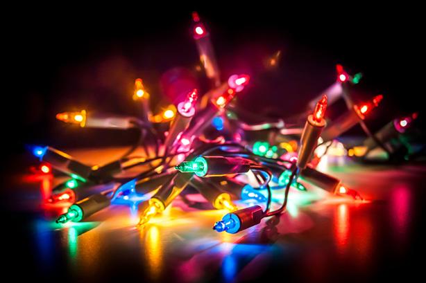Christmas fairy lights isolated on reflecting surface.